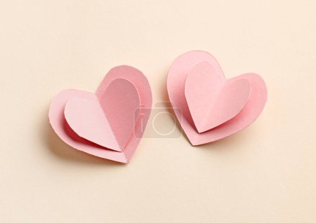 Photo for Decorative pink paper hearts on beige background, top view - Royalty Free Image
