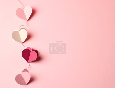 Photo for Heart shaped paper decorations on pink background, top view - Royalty Free Image