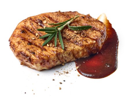 Photo for Freshly grilled juicy steak with rosemary, spices and barbecue sauce isolated on white background - Royalty Free Image
