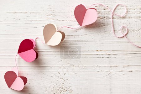 Photo for Heart shaped paper decoration on white wooden background, top view - Royalty Free Image