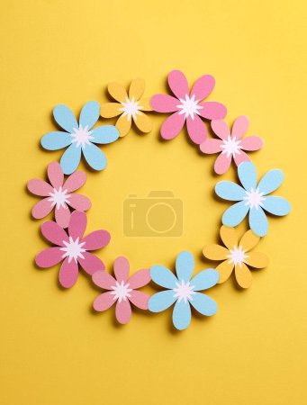 Photo for Beautiful colorful flower shaped wooden decor on yellow background, top view - Royalty Free Image