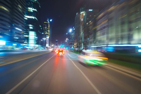 Photo for Driving through the city at night, motion blur - Royalty Free Image