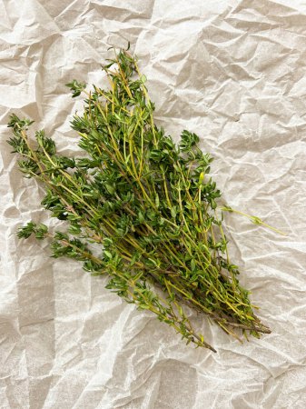 Photo for Green thyme bunch. Bundle of fresh thymes on baking paper - Royalty Free Image