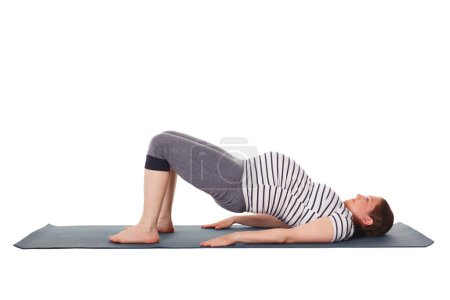 Pregnancy yoga exercise - pregnant woman doing yoga asana Purvottanasana Upward Plank Pose isolated on white background