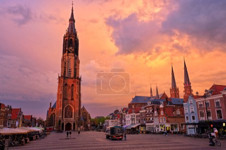 Photo for Delft, Netherlands - May 12, 2017: Nieuwe Kerk New Church protestant church on Delft Market Square Markt with dramatic sky on sunset. Delft, Netherlands - Royalty Free Image