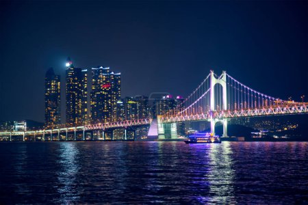 Photo for Gwangan Bridge and skyscrapers illuminated in the night. Busan, South Korea - Royalty Free Image