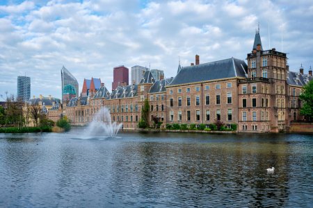 Photo for View of the Binnenhof House of Parliament and the Hofvijver lake with downtown skyscrapers in background. The Hague, Netherlands - Royalty Free Image