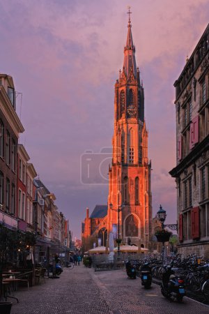 Photo for Delft, Netherlands - May 12, 2017: Nieuwe Kerk New Church protestant church on Delft Market Square Markt with dramatic sky on sunset. Delft, Netherlands - Royalty Free Image