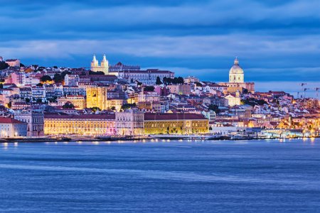 Photo for View of Lisbon over Tagus river with ferry boats in evening twilight. Lisbon, Portugal - Royalty Free Image