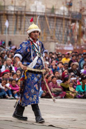 Photo for LEH, INDIA - SEPTEMBER 08, 2012: Dancers in traditional Ladakhi Tibetan costumes perform warlike dance at the Annual Festival of Ladakh Heritage in Leh, India. September 08, 2012 - Royalty Free Image