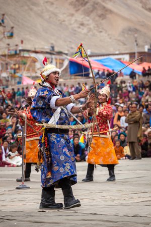 Photo for LEH, INDIA - SEPTEMBER 08, 2012: Dancers in traditional Ladakhi Tibetan costumes perform warlike dance at the Annual Festival of Ladakh Heritage in Leh, India. September 08, 2012 - Royalty Free Image