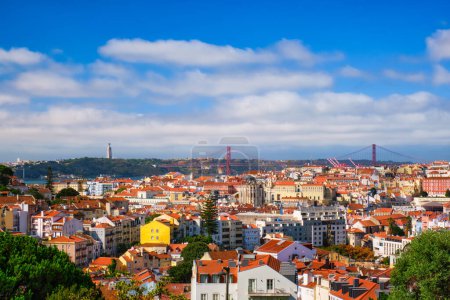 Photo for Lisbon famous view from Miradouro dos Barros tourist viewpoint over Alfama old city district, 25th of April Bridge and Christ the King statue. Lisbon, Portugal. - Royalty Free Image