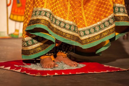 Photo for Bhavai dance performance - folk dance of Rajasthan performer feet close up as she dance on broken glass - Royalty Free Image