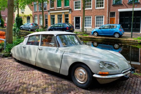 Photo for Delft, Netherlands - May 12, 2017: Retro vintage luxury car Citroen DS in street of Delft near canal - Royalty Free Image