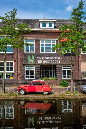 Photo for Delft, Netherlands - May 12, 2017: Retro vintage car Citroen 2CV in street of Delft near canal - Royalty Free Image