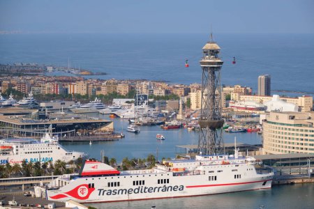 Photo for BARCELONA, SPAIN - APRIL 15, 2019: Aerial view of Barcelona city skyline with city traffic and port with yachts and ferry ships and Barcelona's Port Cable Car. Barcelona, Spain - Royalty Free Image