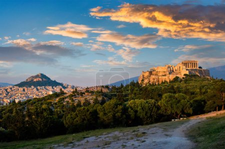 Photo for Famous greek tourist landmark - the iconic Parthenon Temple at the Acropolis of Athens as seen from Philopappos Hill on sunset. Athens, Greece - Royalty Free Image