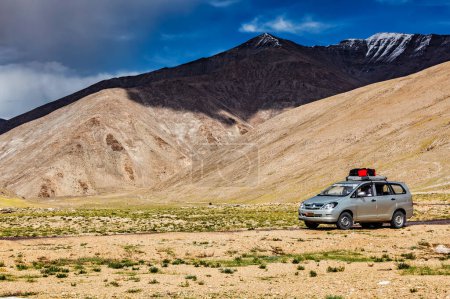 Photo for LADAKH, INDIA - SEPTEMBER 8, 2011: Modern MPV car Toyota Innova on road in Himalayas mountains - Royalty Free Image