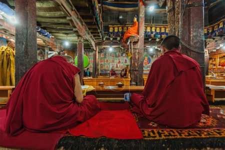 Photo for THIKSEY, INDIA - SEPTEMBER 4, 2011:Tibetan Buddhist monks during prayer in Thiksey gompa (Buddhist monastery) of the Yellow Hat (Gelugpa) sect - the largest gompa in central Ladakh - Royalty Free Image