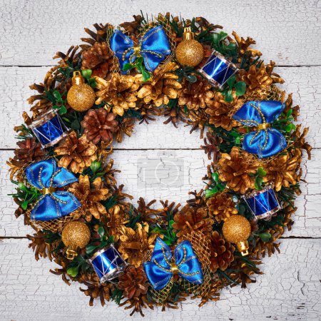 Photo for Christmas wreath on white painted wooden background - Royalty Free Image