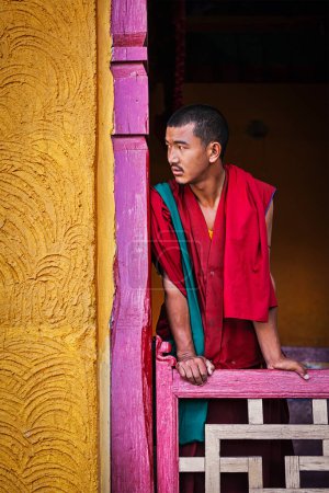 Photo for THIKSEY, INDIA - SEPTEMBER 13, 2012: Young Buddhist monk standing in doorway of of Thiksey gompa, Ladakh, India - Royalty Free Image
