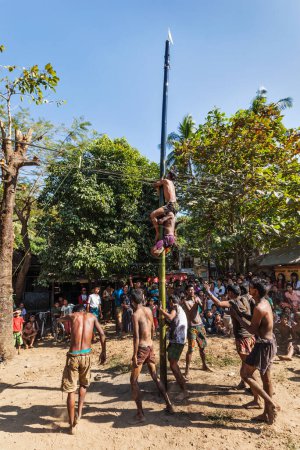 Photo for MYANMAR - JANUARY 4, 2014: Greasy pole climbing competition in village on Myanmar independence day - Royalty Free Image