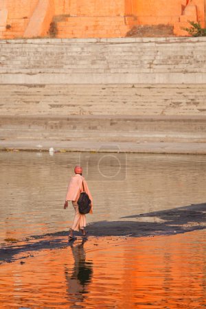 Photo for UJJAIN, INDIA - APRIL 25, 2011: Sadhu crossing holy Kshipra river. Shipra is one of the sacred rivers in Hinduism - Royalty Free Image