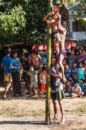 Photo for MYANMAR - JANUARY 4, 2014: Greasy pole climbing competition in village on Myanmar independence day - Royalty Free Image