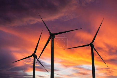 Photo for Green renewable energy concept - wind generator turbines in sky on sunset - Royalty Free Image