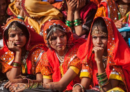 Photo for PUSHKAR, INDIA - NOVEMBER 21, 2012: Unidentified Rajasthani girls in traditional outfits prepare for dance perfomance at annual camel fair Pushkar Mela in Pushkar, Rajasthan, India - Royalty Free Image