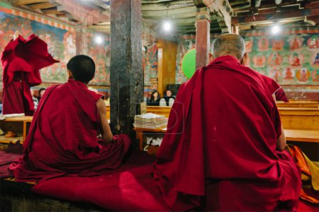 Photo for THIKSEY, INDIA - SEPTEMBER 4, 2011: Tibetan Buddhist monks during prayer in Thiksey gompa Buddhist monastery of Yellow Hat Gelugpa sect the largest gompa in central Ladakh popular tourist attraction - Royalty Free Image