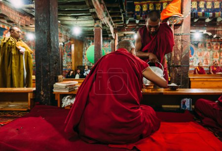 Photo for THIKSEY, INDIA - SEPTEMBER 4, 2011:Tibetan Buddhist monks during prayer in Thiksey gompa (Buddhist monastery) of the Yellow Hat (Gelugpa) sect - the largest gompa in central Ladakh - Royalty Free Image