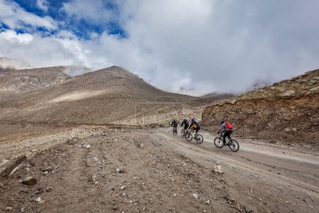 Photo for KARDUNG LA PASS, INDIA - SEPTEMBER 5, 2011: Bicycle tourists in Himalayas ascending to Khardung La highest motorable pass in world. Himalayan bycicle tourism is gaining popularity all over the world - Royalty Free Image
