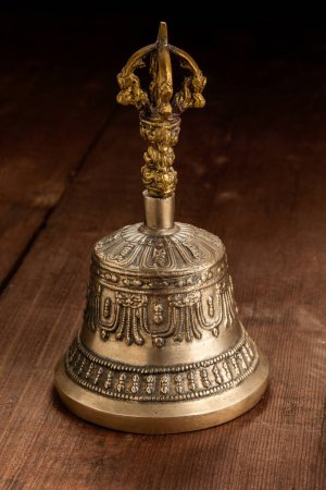 Photo for Tibetan buddhist ceremonial religious bell on wooden background - Royalty Free Image