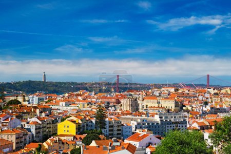 Photo for Lisbon famous view from Miradouro dos Barros tourist viewpoint over Alfama old city district, 25th of April Bridge and Christ the King statue. Lisbon, Portugal. With copyspace - Royalty Free Image