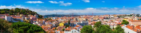Photo for Lisbon famous panorama from Miradouro dos Barros tourist viewpoint over Alfama old district with St. George's Castle, Portugal flag, 25th of April Bridge, Christ the King statue. Lisbon, Portugal. - Royalty Free Image