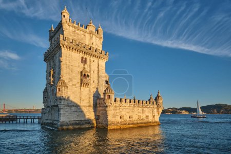 Photo for Belem Tower or Tower of St Vincent - famous tourist landmark of Lisboa and tourism attraction - on the bank of the Tagus River Tejo on sunset. Lisbon, Portugal with tourist yacht boat - Royalty Free Image