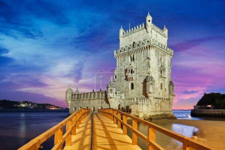 Photo for Belem Tower or Tower of St Vincent - famous tourist landmark of Lisboa and tourism attraction - on the bank of the Tagus River (Tejo) after sunset in dusk twilight with dramatic sky. Lisbon, Portugal - Royalty Free Image