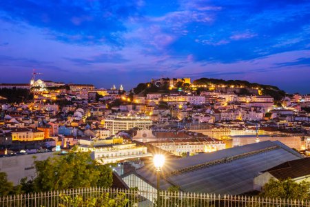 Photo for View of Lisbon famous view from Miradouro de Sao Pedro de Alcantara tourist viewpoint in the evening. Lisbon, Portugal. Camera pan - Royalty Free Image