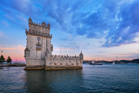 Photo for Belem Tower or Tower of St Vincent - famous tourist landmark of Lisboa and tourism attraction - on the bank of the Tagus River Tejo in evening dusk after sunset with dramatic sky. Lisbon, Portugal - Royalty Free Image