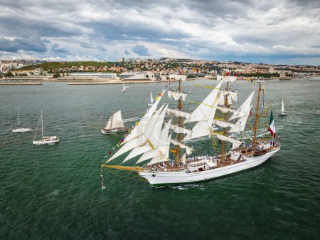 Photo for Aerial drone view of tall ships with sails sailing in Tagus river towards the Atlantic ocean in Lisbon, Portugal - Royalty Free Image