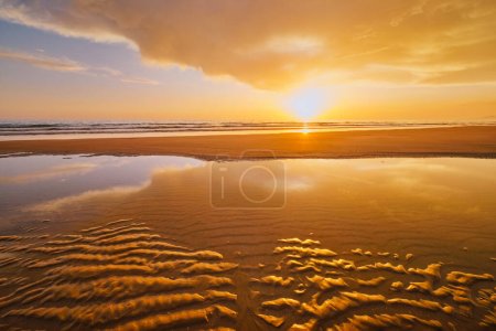 Photo for Atlantic ocean sunset with surging waves at Fonte da Telha beach, Costa da Caparica, Portugal - Royalty Free Image