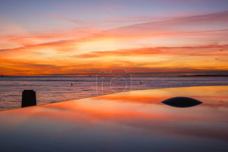 Photo for Fountain and pool near the Champalimaud foundation - Portuguese non-profit foundation for scientific medical research in Belem with sunset reflection - Royalty Free Image