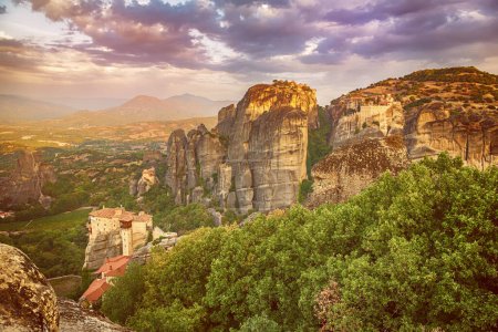 Photo for Meteora, Greece. Sandstone rock formations, the Rousanou and Nikolaos monasteries at sunset. Travel destination background - Royalty Free Image