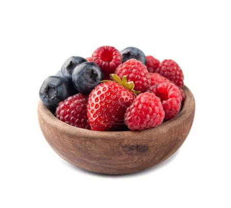 Sweet raspberry, strawberry and blueberry in wooden bowl on white backgrounds.