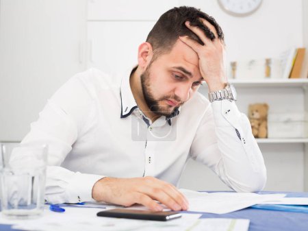 Distressed man having difficulties with paying utility bills and rent