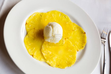 Delicate low calorie fruit carpaccio from thin slices of sweet pineapple served with citrus ice cream.