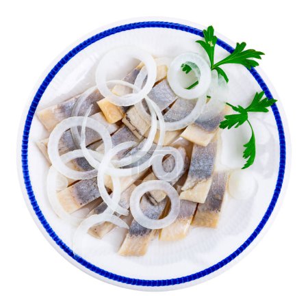 Round orange gray plate with pieces of lightly salted herring fillet,garnished with onion rings and fresh parsley. Isolated over white background