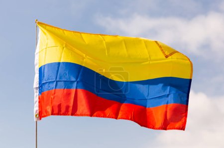Flag of state of Colombia flutters against the sky