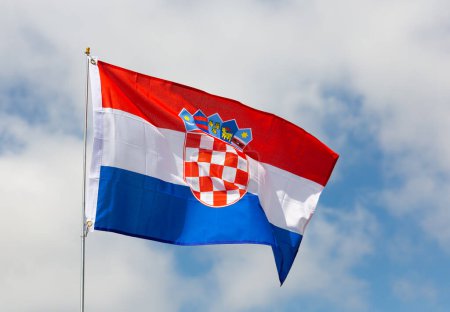 Flag of Croatia flying against a blue sky